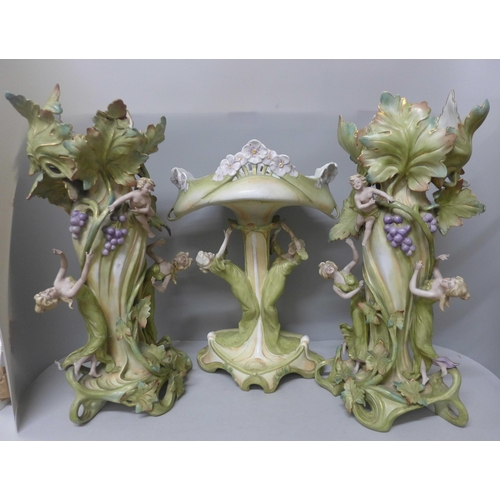 788 - A pair of tall German Art Nouveau figural vases and a tall figural pedestal dish, a/f (damage to fin... 