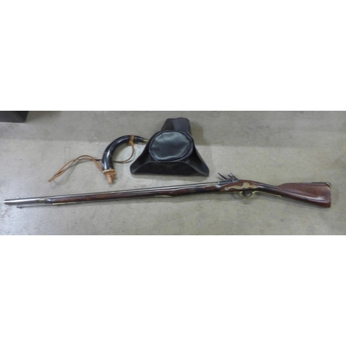 791 - A replica Brown Bess musket, a leather tricorn hat and powder horn