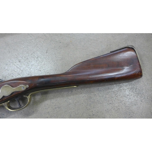 791 - A replica Brown Bess musket, a leather tricorn hat and powder horn