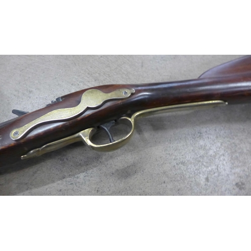 791 - A replica Brown Bess musket, a leather tricorn hat and powder horn