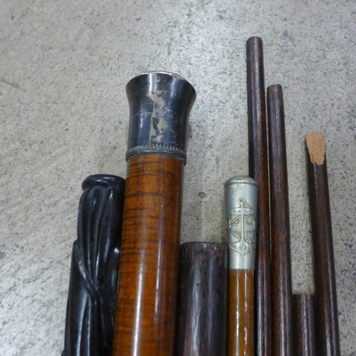 793 - A wooden cane with white metal top, an auctioneers stick, Boys Brigade swagger stick, carved wooden ... 