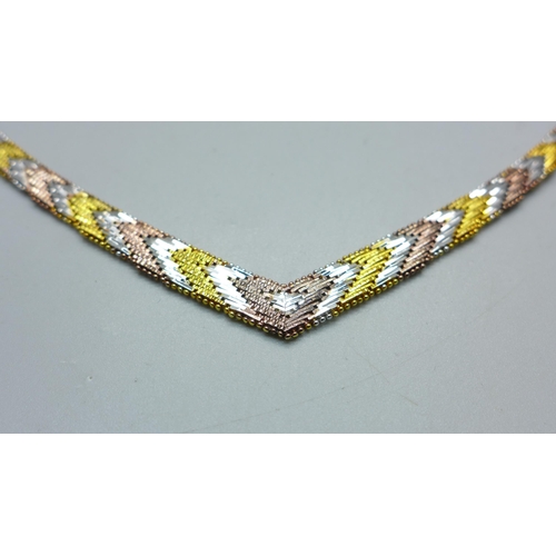 829 - A heavy tri-colour silver-gilt necklace, 56g, and a plated bangle