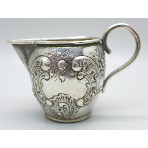 831 - A German embossed silver jug, 42g