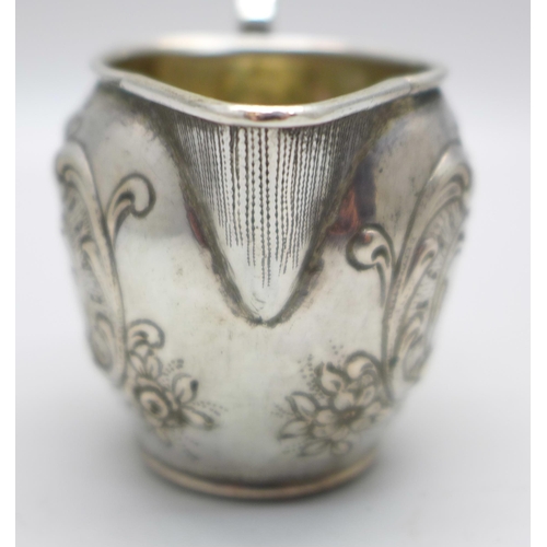 831 - A German embossed silver jug, 42g