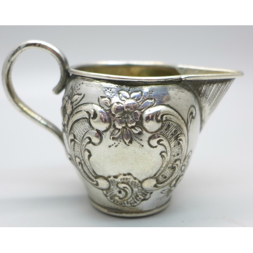 831 - A German embossed silver jug, 42g