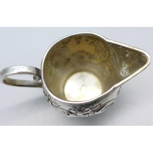 831 - A German embossed silver jug, 42g