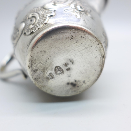 831 - A German embossed silver jug, 42g