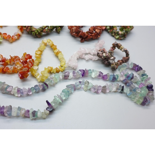 835 - A collection of twenty semi-precious stone bracelets and a necklace