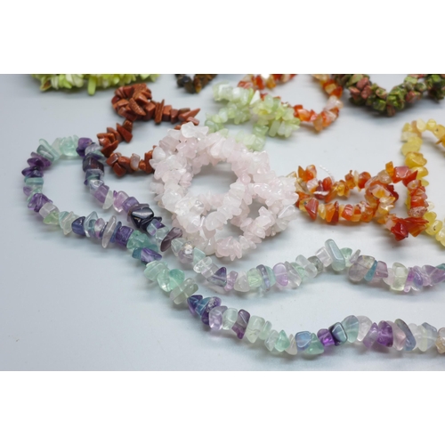 835 - A collection of twenty semi-precious stone bracelets and a necklace