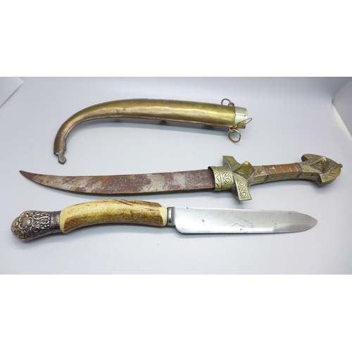 855 - A horn handled knife with silver mount and an Eastern knife with scabbard