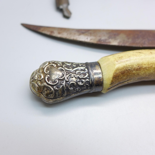 855 - A horn handled knife with silver mount and an Eastern knife with scabbard