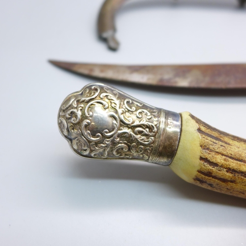 855 - A horn handled knife with silver mount and an Eastern knife with scabbard