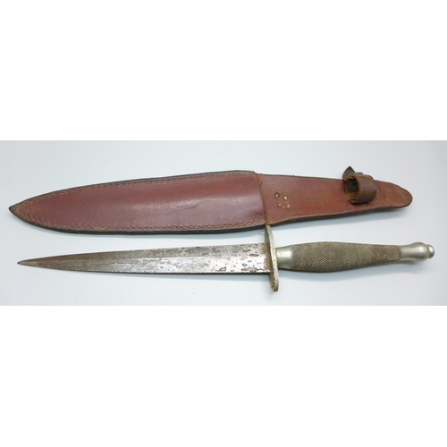 856 - A Commando dagger with scabbard, marked with broad arrow over the number 56