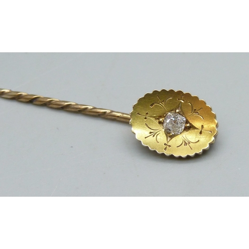 910 - A yellow metal stick pin set with a diamond, 2.6g, cased
