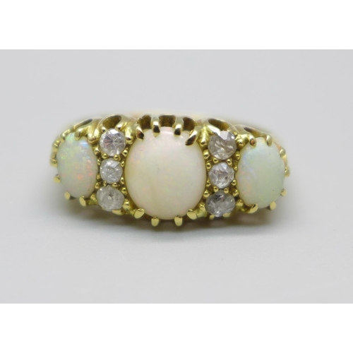 935 - An 18ct gold three stone opal and diamond ring, 3.2g, M