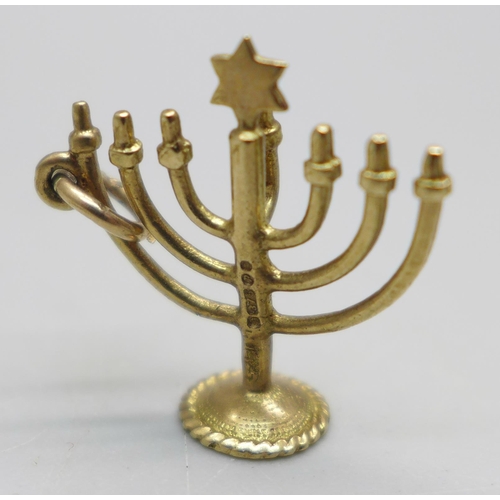 944 - A 9ct gold Jewish Menorah charm and a 9ct gold cross pendant, 2.4g