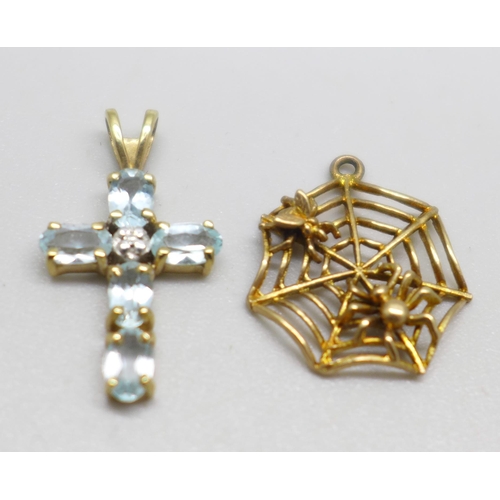 950 - A 9ct gold and blue stone cross pendant and a 9ct gold spider's web charm, 2.1g