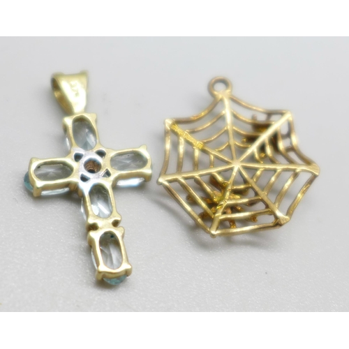 950 - A 9ct gold and blue stone cross pendant and a 9ct gold spider's web charm, 2.1g