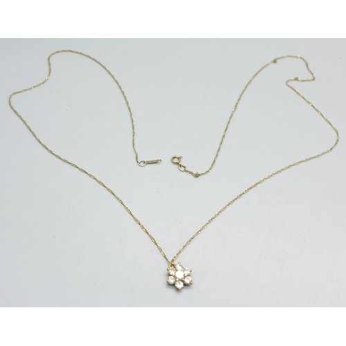 953 - A seven stone yellow metal pendant, (tests as 9ct gold), on a 9ct gold chain, 1.7g