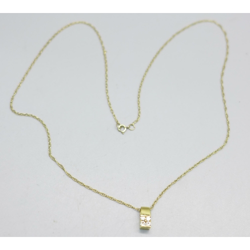 957 - An 18ct gold and diamond pendant on a 9ct gold chain, 1.6g