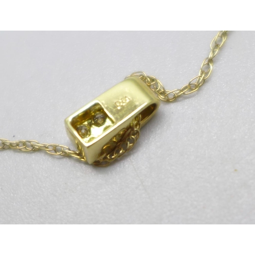 957 - An 18ct gold and diamond pendant on a 9ct gold chain, 1.6g