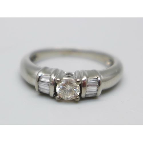 980 - An 18ct white gold and diamond ring, 4.2g, M, centre stone approximately 0.25ct weight