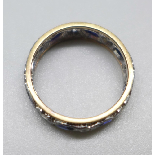 992 - A 9ct yellow and white gold, blue and white stone eternity ring, 3.4g, L