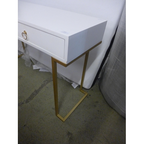 1575 - A white console table with gold legs