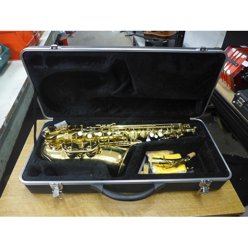 2076 - A Windsor saxophone with spare reeds, polishing cloths and a protective hard case