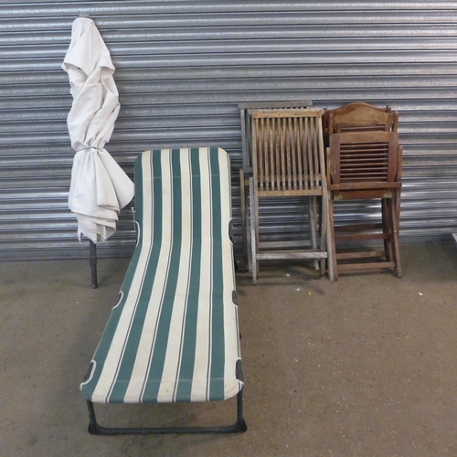 2189 - A quantity of garden furniture including two pairs of chairs, a parasol and a sun bed