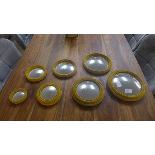 1353 - A set of seven gold velvet framed convex mirrors