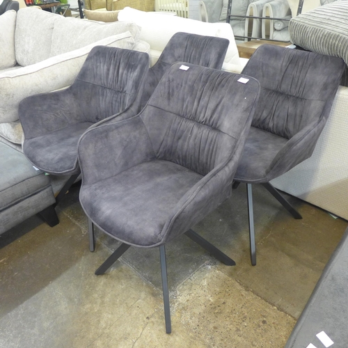 1495 - A set of four charcoal velvet swivel velvet dining chairs * This lot is subject to VAT