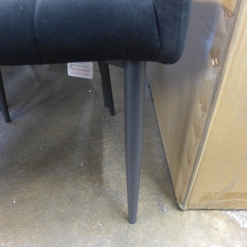 1500 - A set of four Kos black velvet dining chairs * This lot is subject to VAT