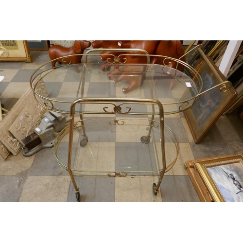 412 - A mid 20th Century brass and glass topped cocktail trolley