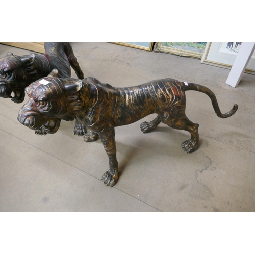 419 - A pair of large bronze tigers of tigers