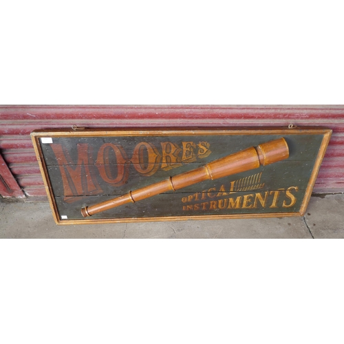 454 - A pailnted wooden Moore's Optical Instrument Sign