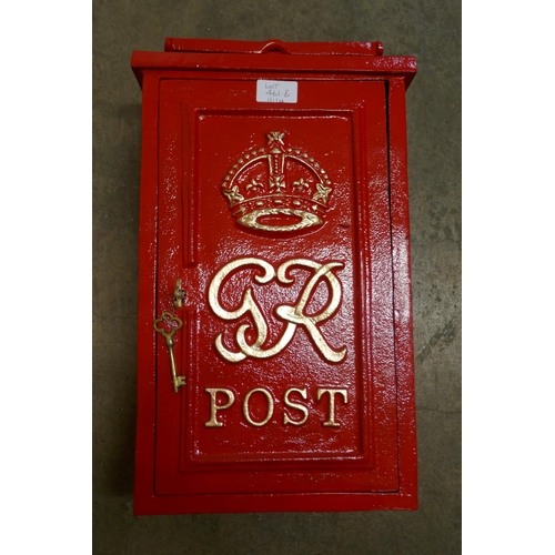 461B - A red painted cast iron post box, with key