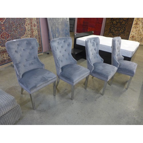 1563 - A set of four grey velvet dining chairs * This lot is subject to VAT