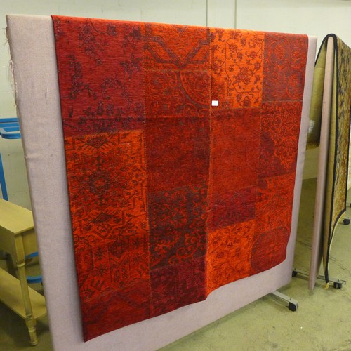 1566 - A rich red ground patchwork designer rug, with anti slip backing, 230 x 160cm