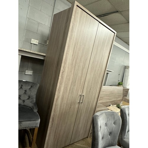 1519 - A wood effect bedroom suite including a super king bedframe, double wardrobe, eight drawer chest and... 