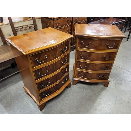 292 - A pair of small yew wood serpentine chests of drawers