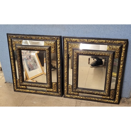 480 - A pair of Victorian ebonised and parcel gilt cushion framed mirrors