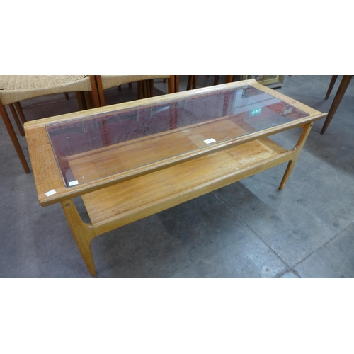 126 - A teak and glass topped rectangular coffee table