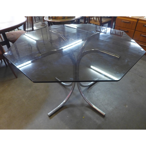 150 - A chrome and hexagonal glass topped dining table