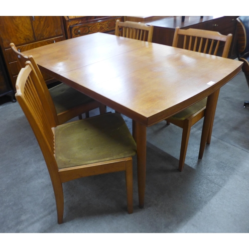 153 - A teak rectangular extending dining table and four chairs