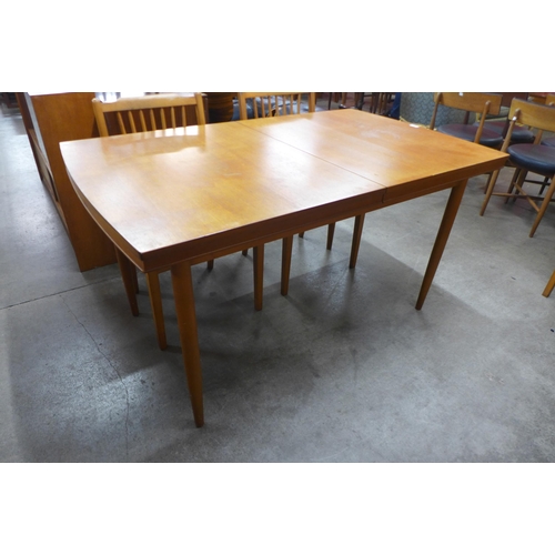 153 - A teak rectangular extending dining table and four chairs