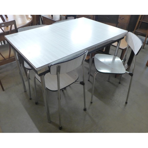 192 - A chrome and white Formica extending kitchen table and four chairs