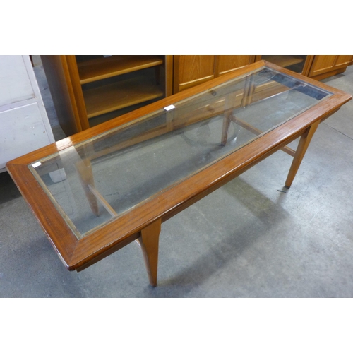 230 - A teak and glass topped rectangular coffee table