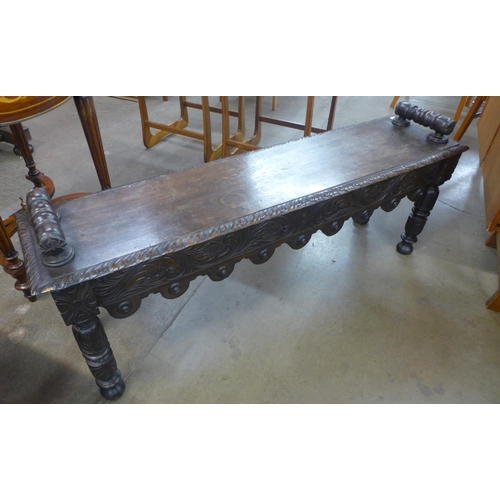 243 - A Victorian Jacobean Revival carved oak window seat