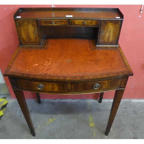 249 - A Regency style mahogany and red leather topped bonheur de jour